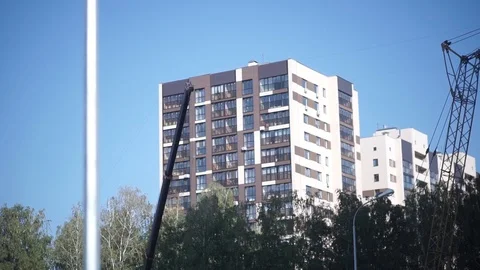 Crane arm on the background of multistory House Stock Footage 98944156
