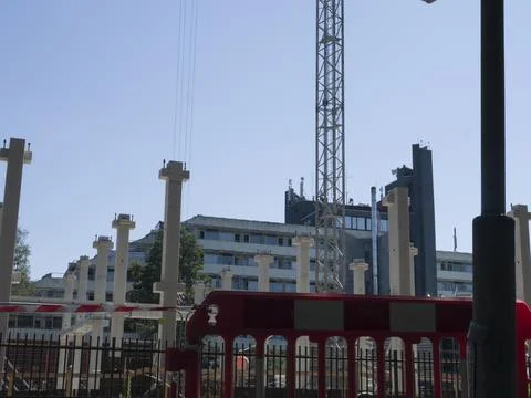 Crane in background working on building under construction. Building framework Fotos de archivo