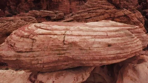Crane up from behind large rock in Red Rock Canyon to reveal canyon landscape Video stock 105020261