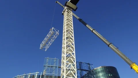 Crane being constructed in sections by smaller crane. Lifting the crane Vídeos de archivo 94621908