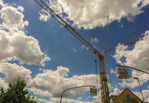 A crane below a cloudy summer sky Stock Photos