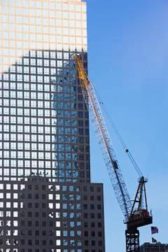 Crane beside skyscraper Stock Photos