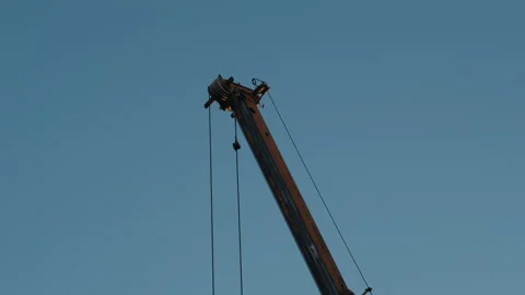 Crane Boom Moving Left to Right with Hanging Cable Stock Footage 321622804