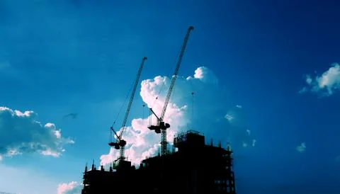 Crane of building construction against beautiful dusky sky Stock Photos