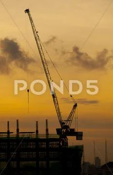 Crane of building construction on dusky sky Stock Photos