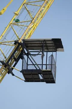 A crane with a cage on the side Stock Photos