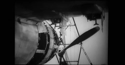 Crane carrying propeller towards B-17 bomber Stock Footage 43395602