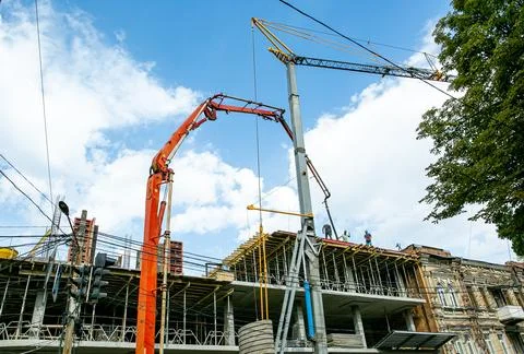 Crane on Construction on blue sky background. Tower cranes in action during.. Stock Photos