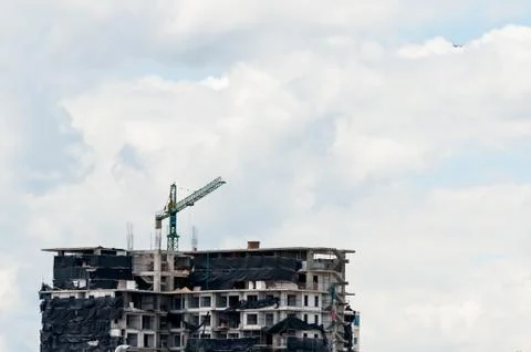 Crane in construction site building Stock Photos