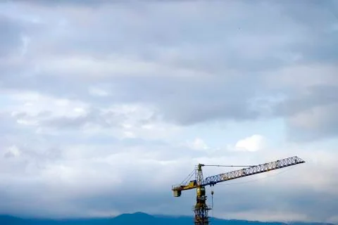 Crane Construction site in front of the cloudy sky Stock Photos