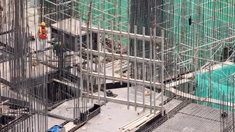 A crane at a construction site lowers a load Stock Footage 340330721