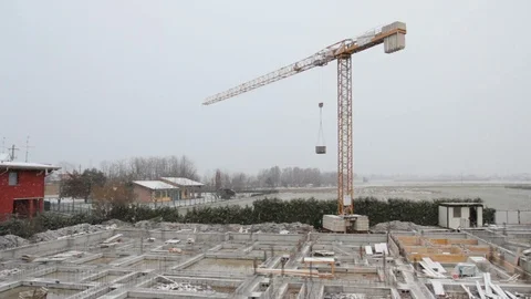 Crane on construction site stopped during a snowfall Stock Footage 89825472