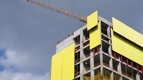 Crane on construction site of yellow building Stock Footage 279759926