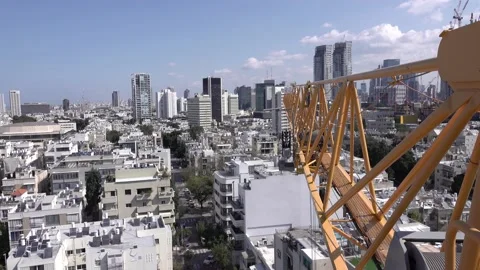 Crane construction work, View of Tel Aviv, Crane in motion Stockbeeldmateriaal 196971591