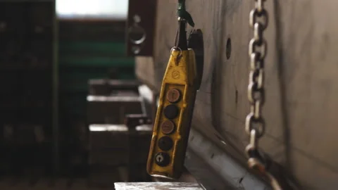 Crane control panel in the workshop. Large yellow remote control with buttons Stock Footage 144211737
