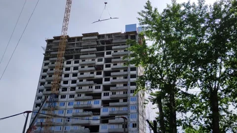 A crane delivers cargo for the construction of a high-rise building Stock Footage 196252725