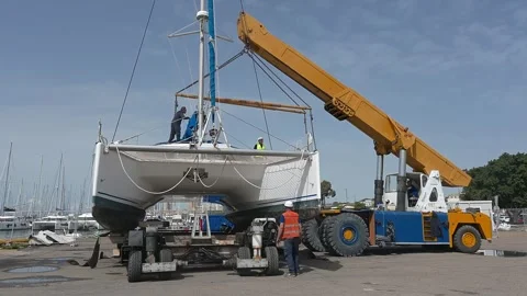 Crane detached after setting down catamaran Stock Footage 310513056