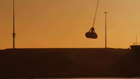 Crane discharging coals during sunset. 4K footage. Stock Footage 112980492