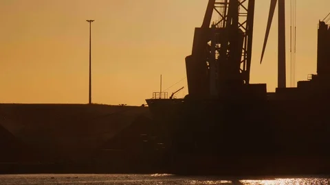 Crane discharging coals during sunset.4K Stock Footage 111337880