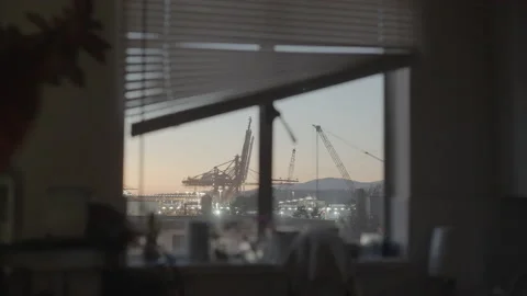 Crane in the distance from inside apartment window Stock Footage 226453595