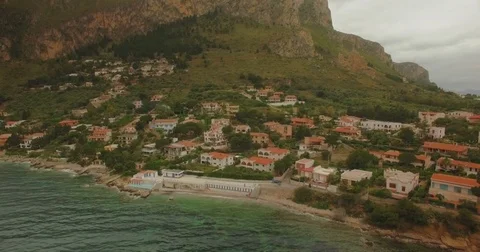 Crane down looking at the houses in Capo Zafferano, Sicily Stock Footage 76929504