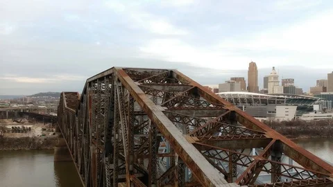 Crane down shot of train crossing bridge in large urban area Stock-Footage 100416499