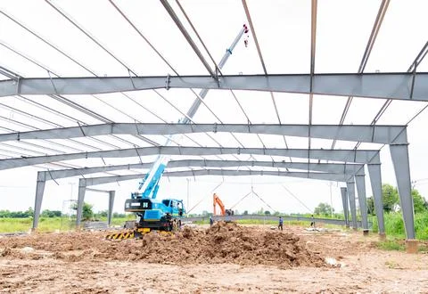 A crane driver is using a crane to lift the roof structure onto the steel p.. Stock Photos