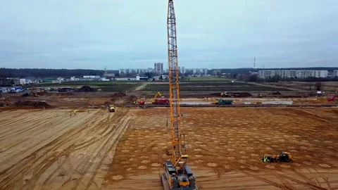 Crane dropping a heavy weight for dynamic soil compaction - aerial 動画素材 221010025