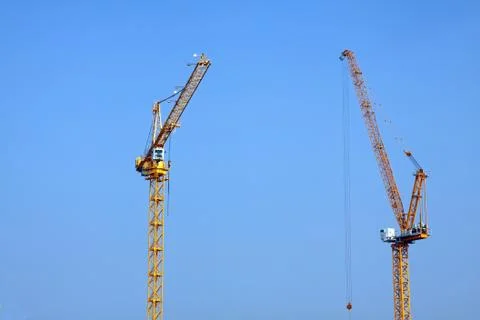 The crane elevating against the blue sky Stock Photos