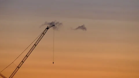 Crane with flashing light at sunrise - flying crow - orange sky - real time Stock Footage 142019784