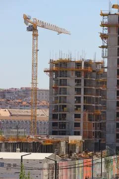 A crane in front of a building Stock Photos