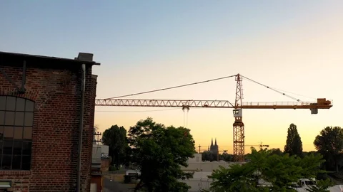 Crane in front of Cathedral that disappears behind old brick Loft Stock Footage 111963643