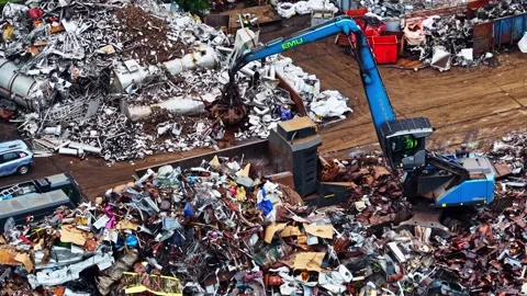 Crane Grabs Scrap Metal Piles And Feeds Them Into Press Machine Stock Footage 339644170