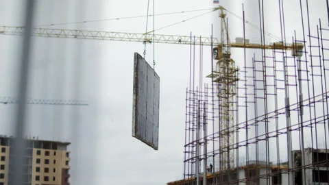 Crane hoisting large formwork panel above reinforced structure Stock Footage 327290597