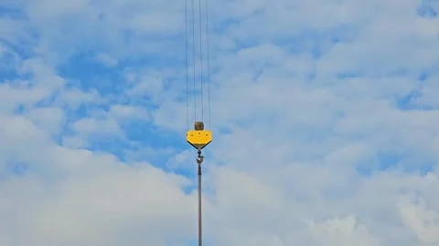 Crane hook block with cables against a cloudy blue sky. Industrial equipment Stock Footage 297612849