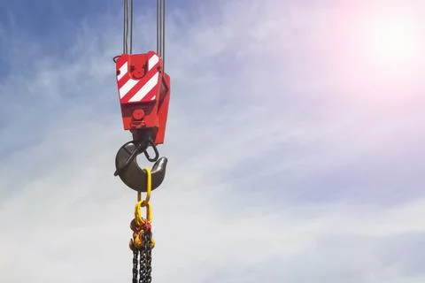 Crane hook on blue sky background, construction work concept Stock Photos