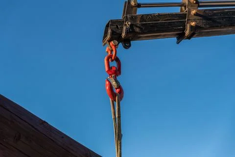 Crane hook lifting large log Foto stock