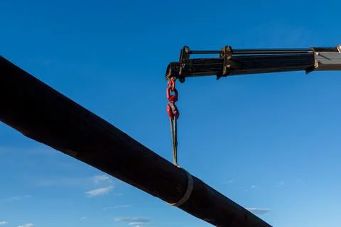 Crane hook lifting large log Stock Photos