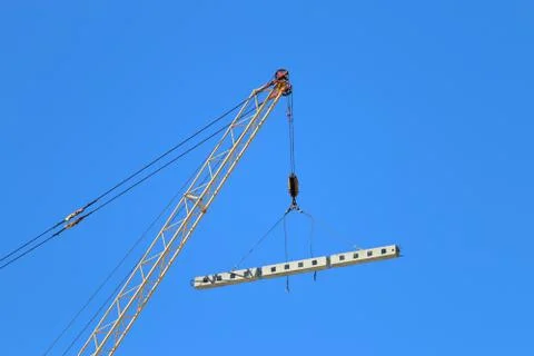 Crane hook with load and for building under construction and blue sky at sunn Stock Photos