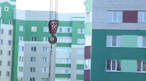 Crane hook  moves on the background an apartment building Stock Footage 62802241