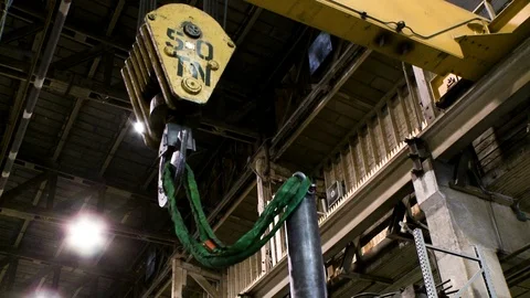 Crane hook pulling large canvas wrapped chain or rope in warehouse 2 Stock Footage 123728278