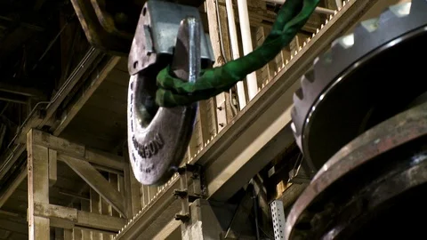 Crane hook pulling large canvas wrapped chain or rope in warehouse 1 Stock Footage 123728413