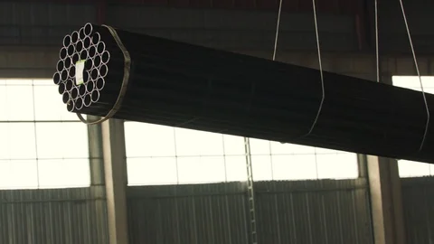Crane Hook with Stack of new round and shiny steel metal tubes 스톡 동영상 120821778