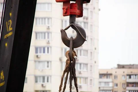 Crane hook. Tower Crane Hoist Rope against the blue sky and new building Stock Photos