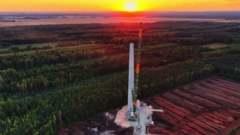 Crane Installs Wind Turbine Sections at Sunset Stock Footage 315263115