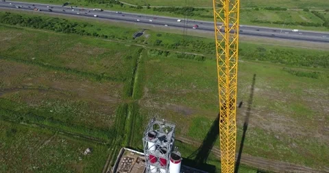 Crane lift chimney pipe segment. Аerial, workers on the top Video stock 68788269