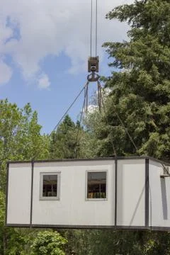 Crane lifting and moving container house Stock Photos