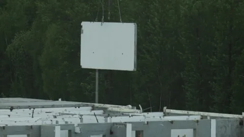 Crane lifting and rotating concrete panel for residential building construction Stock Footage 328359204