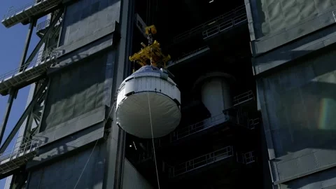 Crane lifting Boeing OFT-2 Starliner spacecraft at Vertical Integration Facility Stock Footage 274264840