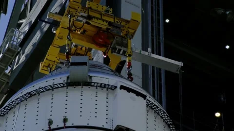 Crane lifting Boeing OFT-2 Starliner spacecraft at Vertical Integration Facility Stock Footage 274264858